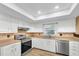 Updated kitchen featuring stainless steel appliances, sleek countertops, and modern flooring, designed for both style and function at 12946 116Th St, Largo, FL 33778