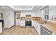 Well-equipped kitchen with white cabinetry, stainless steel appliances, and ample counter space, ideal for culinary enthusiasts at 12946 116Th St, Largo, FL 33778