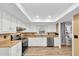 Bright kitchen with modern appliances, white cabinets, and a view into the adjacent dining area, perfect for cooking and entertaining at 12946 116Th St, Largo, FL 33778