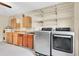 Laundry room featuring modern appliances, cabinets, sink, storage rack, and spacious layout at 12946 116Th St, Largo, FL 33778