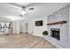 Open-concept living room featuring a brick fireplace, TV, and access to dining and other areas at 12946 116Th St, Largo, FL 33778