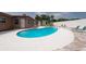 Backyard showcasing a kidney-shaped pool, patio area, lounge chairs, and white wall with greenery at 12946 116Th St, Largo, FL 33778