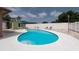 Backyard featuring a kidney-shaped pool, lounge chairs, and a patio area with lush landscaping at 12946 116Th St, Largo, FL 33778