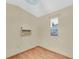 Small room with hardwood floors, window, and air conditioner at 12946 116Th St, Largo, FL 33778