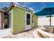 View of the exterior of the green painted shed at 12946 116Th St, Largo, FL 33778