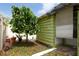 This is an exterior of the shed next to a tree at 12946 116Th St, Largo, FL 33778