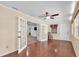 Bright sunroom with hardwood floors, ceiling fan, and access to the main house and backyard at 12946 116Th St, Largo, FL 33778