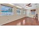 Bright and airy sunroom with hardwood floors, featuring multiple windows and backyard access at 12946 116Th St, Largo, FL 33778