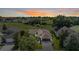 Beautiful aerial view of home with lush landscaping and sunset sky at 13238 Chipout Ln, Hudson, FL 34669
