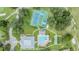 Aerial view of community amenities featuring a pool, tennis, pickleball and shuffleboard courts at 13238 Chipout Ln, Hudson, FL 34669