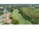 Expansive aerial view of the golf course and community landscape filled with lush greenery at 13238 Chipout Ln, Hudson, FL 34669