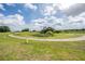 Lush backyard featuring a scenic walking path, providing a peaceful outdoor experience at 13238 Chipout Ln, Hudson, FL 34669
