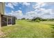 Spacious backyard with a screened enclosure and beautiful views of the landscape at 13238 Chipout Ln, Hudson, FL 34669