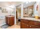 Bathroom with double sinks, granite counters, and access to the bedroom at 13238 Chipout Ln, Hudson, FL 34669
