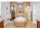Luxurious bathroom with a large tub, walk-in shower, and separate toilet area at 13238 Chipout Ln, Hudson, FL 34669