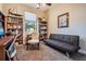 Comfortable bedroom with a futon sofa and desk with natural light, ideal for use as an office or study at 13238 Chipout Ln, Hudson, FL 34669