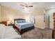 Spacious bedroom with a ceiling fan, carpet, and ensuite bathroom at 13238 Chipout Ln, Hudson, FL 34669