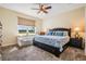 Comfortable bedroom with a ceiling fan, plush carpet, and lots of natural light at 13238 Chipout Ln, Hudson, FL 34669