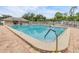 Inviting community pool with clear blue water and a secure fenced perimeter at 13238 Chipout Ln, Hudson, FL 34669