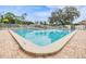 Large community pool with brick surround, perfect for relaxation and recreation under blue skies at 13238 Chipout Ln, Hudson, FL 34669