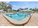 Serene community pool enclosed by fencing, providing a safe and enjoyable swimming experience at 13238 Chipout Ln, Hudson, FL 34669
