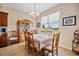 Dining room features a large window with views and traditional furniture at 13238 Chipout Ln, Hudson, FL 34669
