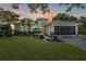 Charming single story home with manicured lawn and tropical landscaping at 13238 Chipout Ln, Hudson, FL 34669