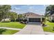 Well-maintained single-story home with a two-car garage and landscaped front yard at 13238 Chipout Ln, Hudson, FL 34669