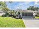Charming single-story home with a manicured lawn and screened garage offers curb appeal at 13238 Chipout Ln, Hudson, FL 34669