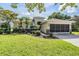 Charming single-story home with a manicured lawn and screened garage offers curb appeal at 13238 Chipout Ln, Hudson, FL 34669