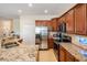 Bright kitchen showcases wood cabinetry, granite counters, and stainless steel appliances at 13238 Chipout Ln, Hudson, FL 34669