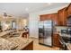 Open kitchen featuring granite counters, stainless steel appliances, and tile flooring at 13238 Chipout Ln, Hudson, FL 34669