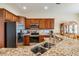 Well-lit kitchen boasts granite countertops, stainless appliances, and wood cabinets at 13238 Chipout Ln, Hudson, FL 34669