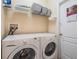 Convenient laundry room with a modern washer and dryer, and storage shelving at 13238 Chipout Ln, Hudson, FL 34669
