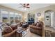 Comfortable living room features a ceiling fan and patio access at 13238 Chipout Ln, Hudson, FL 34669