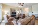 Open-concept living room with neutral walls, comfortable seating and tile flooring at 13238 Chipout Ln, Hudson, FL 34669