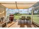 Relaxing screened patio with a grill and outdoor seating offering views of the serene landscape at 13238 Chipout Ln, Hudson, FL 34669