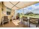 Inviting screened patio with seating and a grill, perfect for enjoying the expansive outdoor scenery at 13238 Chipout Ln, Hudson, FL 34669