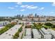 Aerial view showcases the modern townhomes with the city skyline in the distance, under a sunny sky at 1330 W Gray St # 1, Tampa, FL 33606