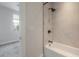 Updated bathroom with a shower-tub combo and large window to bedroom at 1330 W Gray St # 1, Tampa, FL 33606
