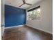 Bedroom with hardwood floors, a blue accent wall, and natural light at 1330 W Gray St # 1, Tampa, FL 33606