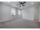 Minimalist bedroom with hardwood flooring, ceiling fan, and two windows for natural light at 1330 W Gray St # 1, Tampa, FL 33606