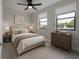 Bedroom with neutral tones, ceiling fan, and windows providing natural light at 1330 W Gray St # 1, Tampa, FL 33606