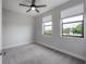 Bright bedroom with carpet flooring, ceiling fan and two large windows at 1330 W Gray St # 1, Tampa, FL 33606