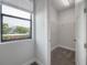 Well-lit walk-in closet offers carpet flooring, window and wire shelving at 1330 W Gray St # 1, Tampa, FL 33606