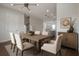 Well-lit dining area with modern lighting, wood table, and view into the kitchen at 1330 W Gray St # 1, Tampa, FL 33606