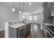 Bright kitchen featuring a stylish island with marble countertops and stainless steel appliances at 1330 W Gray St # 1, Tampa, FL 33606
