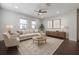 Bright living room featuring neutral furniture, area rug, ceiling fan, and natural light from the windows at 1330 W Gray St # 1, Tampa, FL 33606