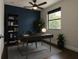 Home office featuring a desk, bookshelf, accent wall, and window at 1330 W Gray St # 1, Tampa, FL 33606