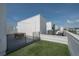 This rooftop deck has artificial grass, outdoor furniture, and string lights for relaxing and entertaining at 1330 W Gray St # 1, Tampa, FL 33606